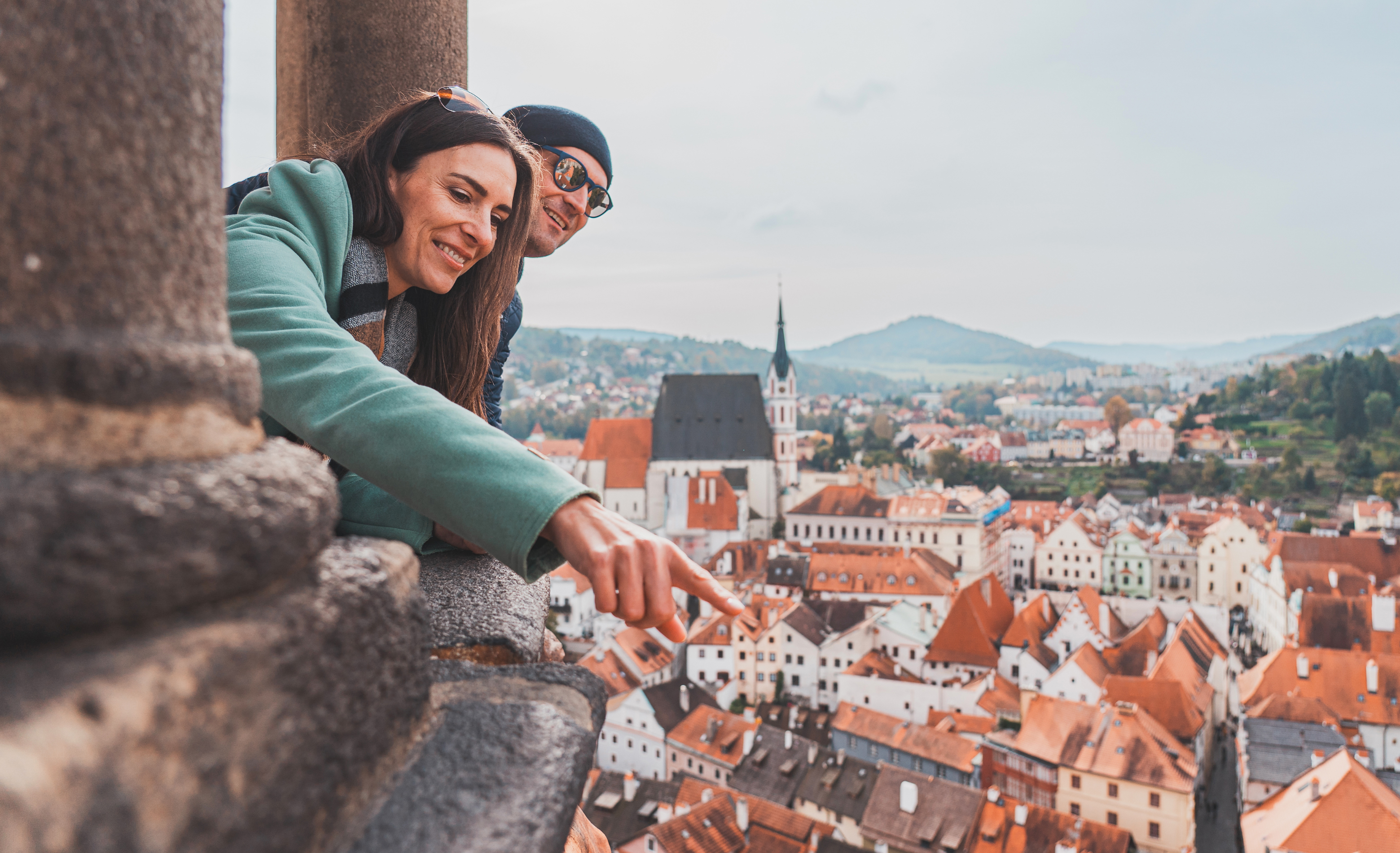 Couple enjoying the panoramic view from the tower over Český Krumlov’s historic old town.