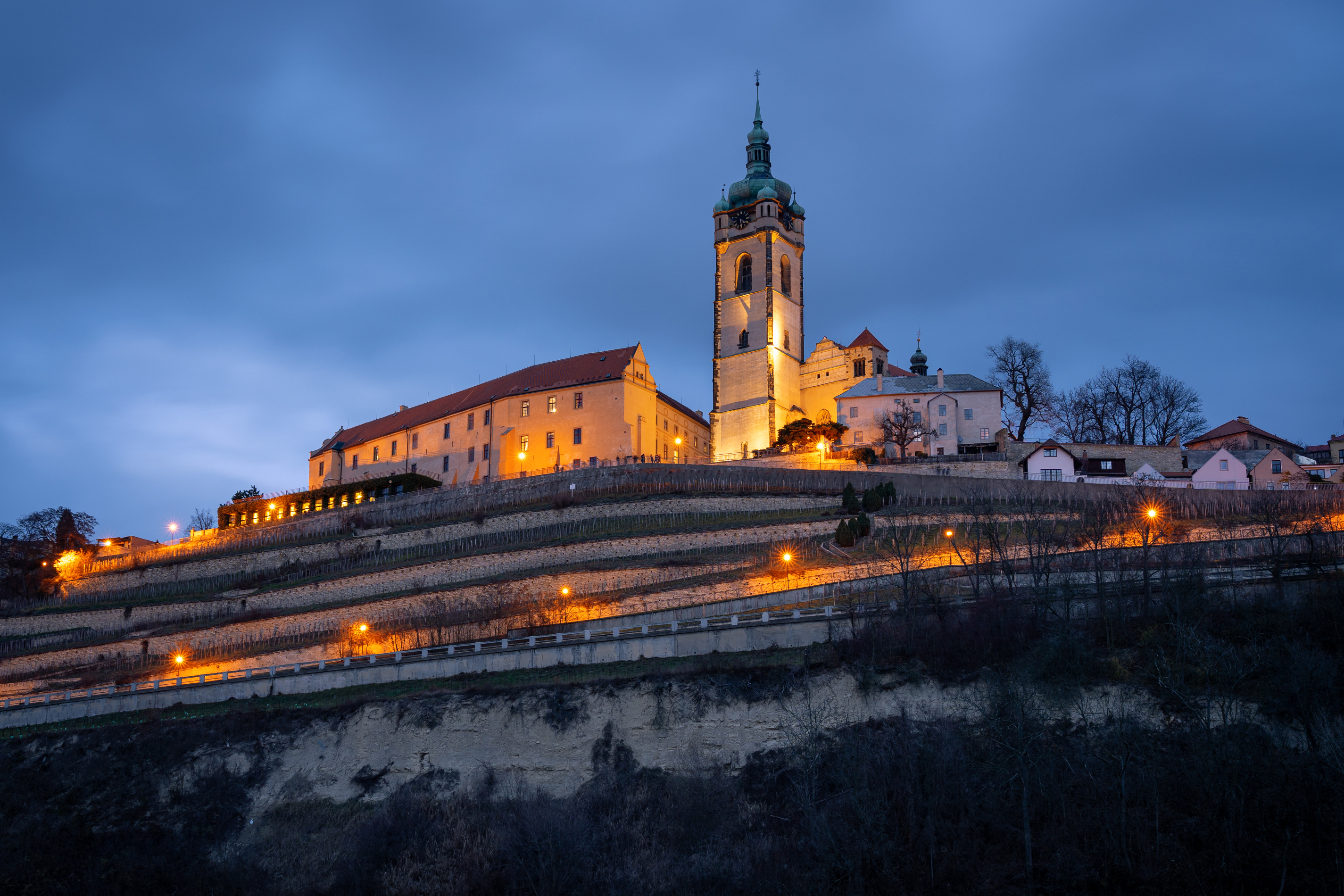 Mělník Castle wine terraces and vineyards at blue hour above the Elbe–Vltava confluence