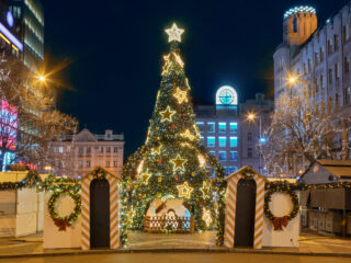 Christmas tree at Wenceslas Square in Prague with nativity scene and festive decorations.