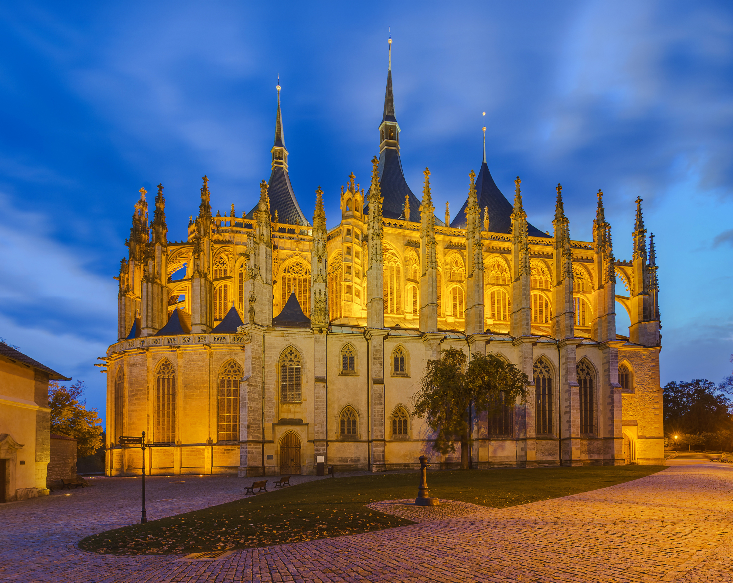 St. Barbara’s Cathedral in Kutná Hora illuminated at evening with Gothic architecture and blue hour sky