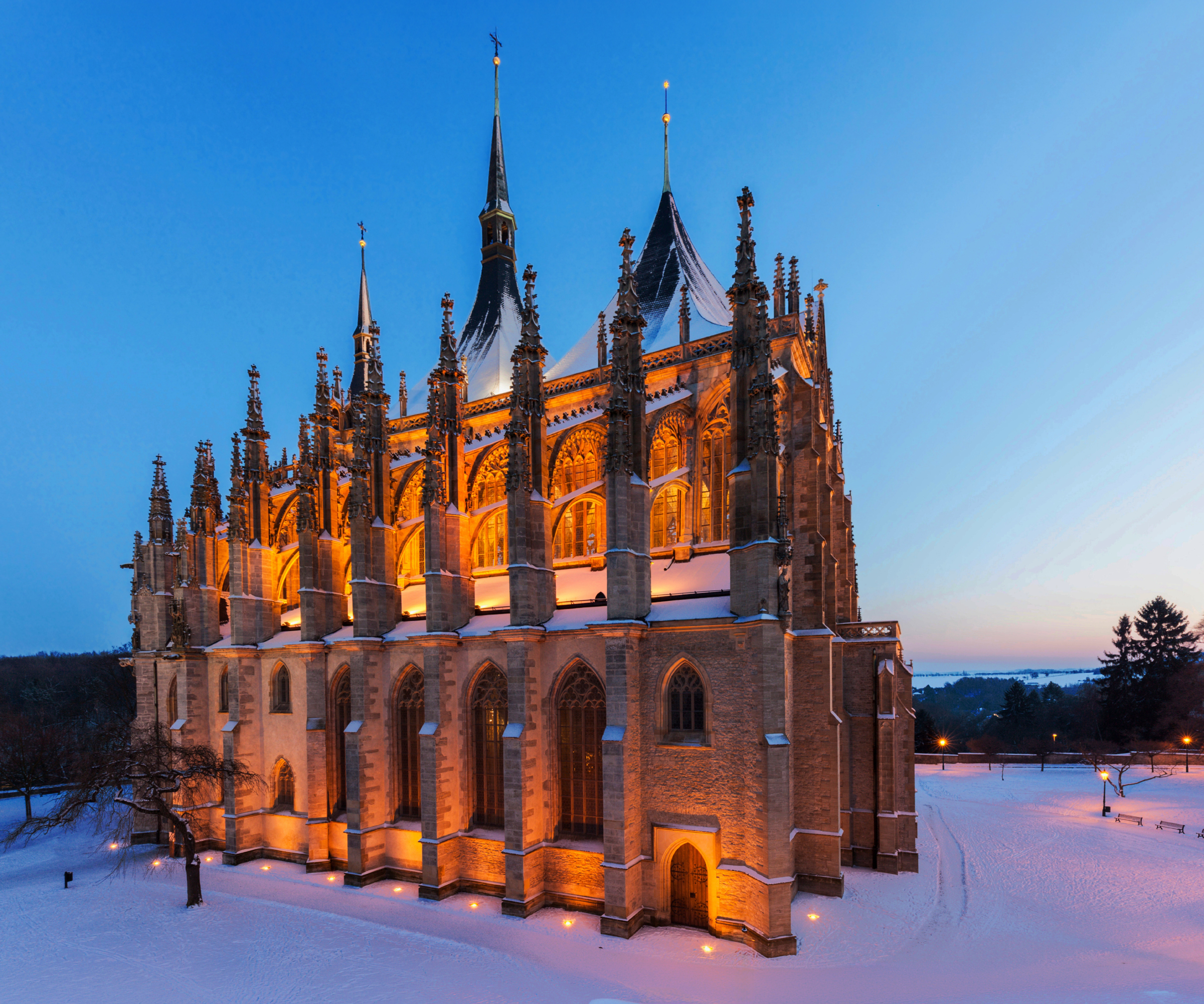 St. Barbara’s Cathedral in Kutná Hora illuminated at winter evening with snow-covered surroundings