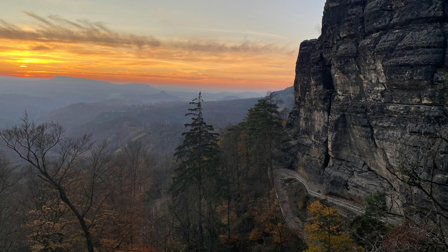 Dramatic sunset over sandstone cliffs and valley in Bohemian Switzerland National Park Czech Republic