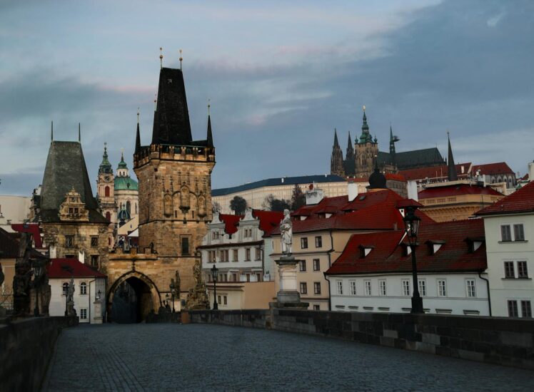Charles Bridge in Prague at sunrise with castle in background