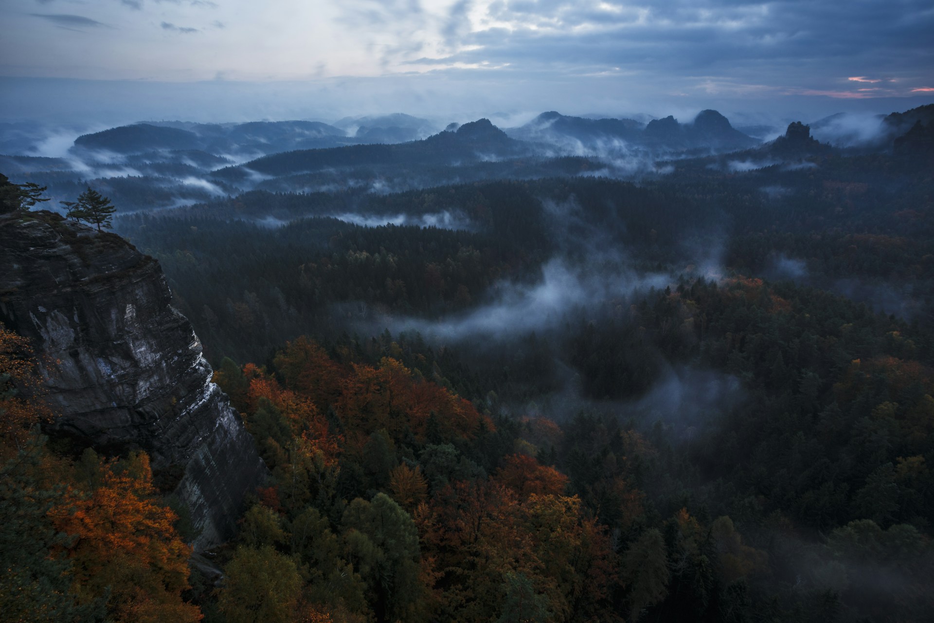 Dramatic sunset over sandstone cliffs and valley in Bohemian Switzerland National Park Czech Republic