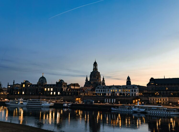 Dresden baroque skyline along the Elbe river at dusk with moored boats