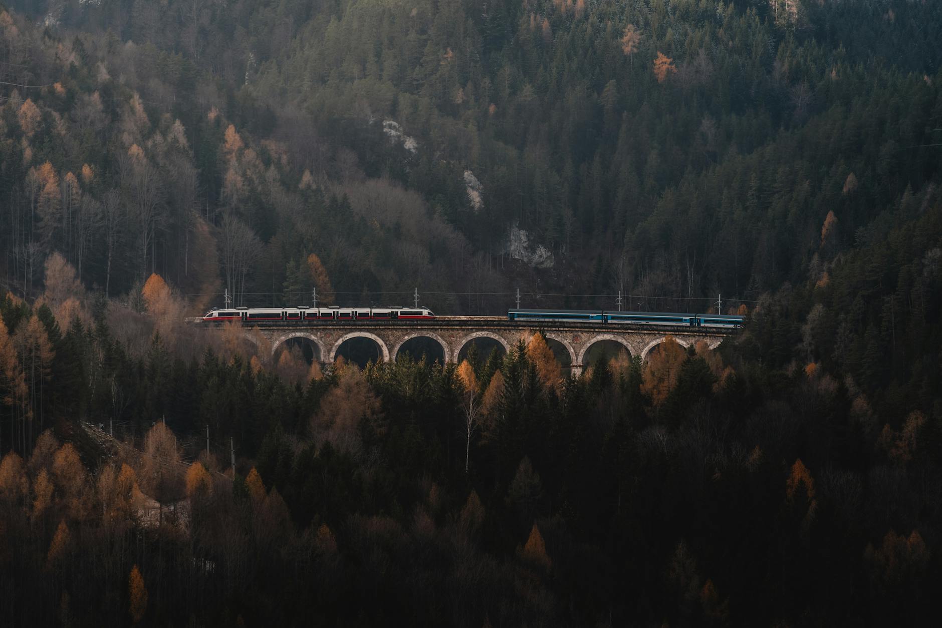ÖBB Railjet train crossing the historic Semmering Viaduct in Austria — the scenic railway route from Prague to Vienna passes through the Austrian Alps