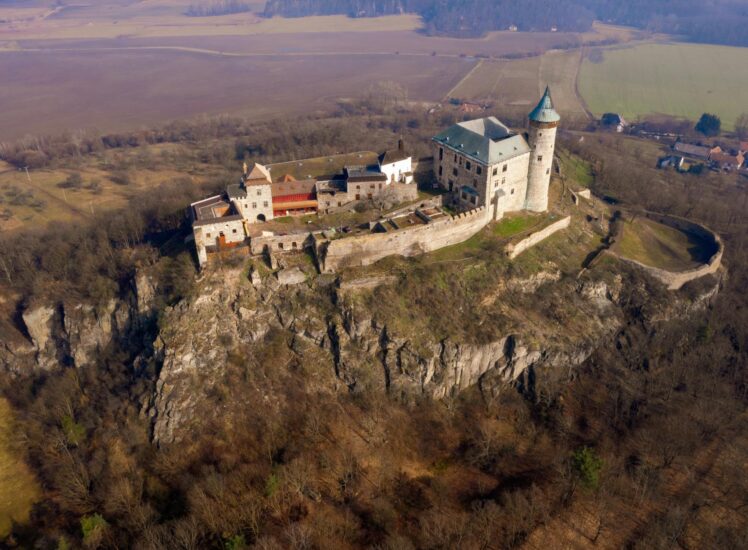 Telč castle reflected in the pond with Renaissance town in background