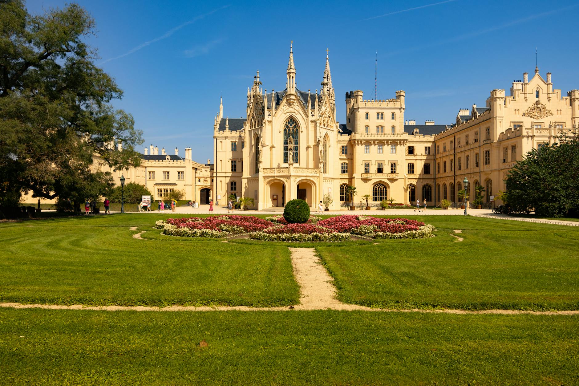 Beautiful Lednice Castle in the Czech Republic surrounded by lush gardens and a clear blue sky.