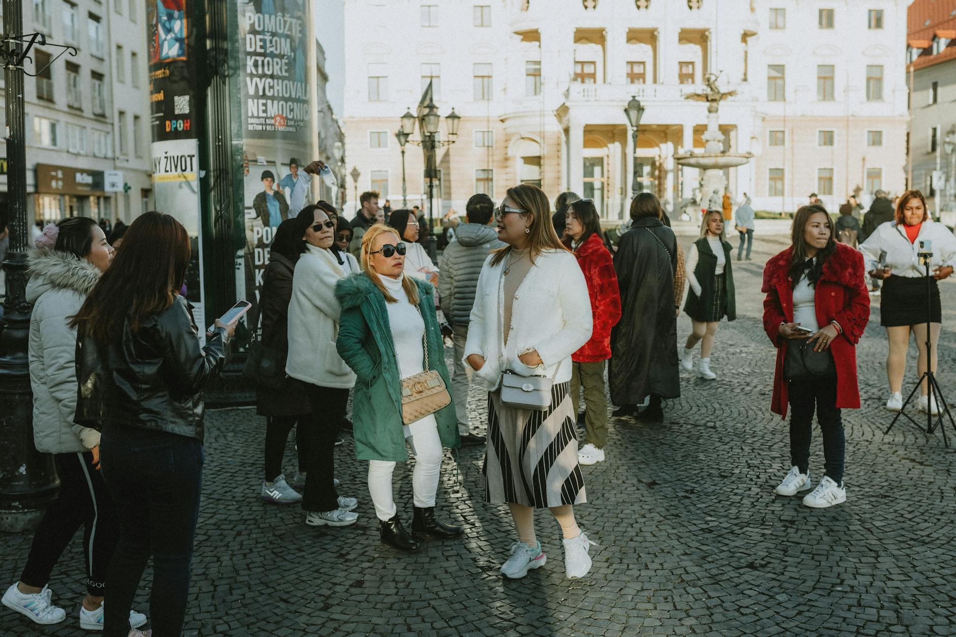 Tourists walking Prague historic streets — book a private guided tour for the best experience